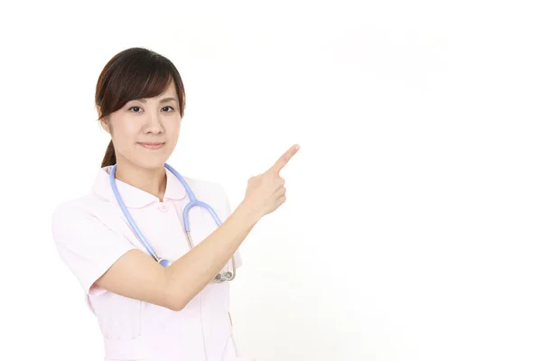 Asiatische Weibliche Krankenschwester Zeigt Mit Ihrem Finger — Stockfoto