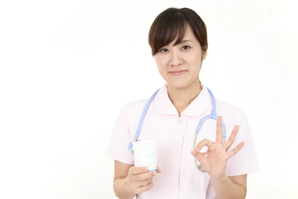 Uśmiecha Się Kobieta Pielęgniarka Ręka Znak — Zdjęcie stockowe