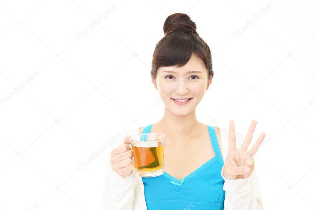 Asian woman enjoys having tea