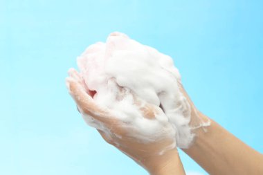Foam of soap and female hands