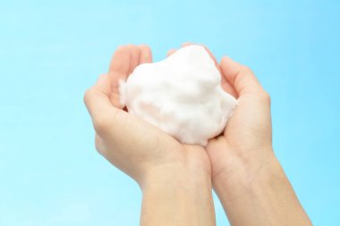 Foam of soap and female hands