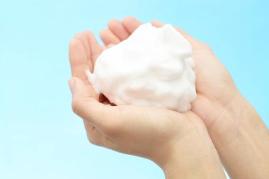 Foam of soap and female hands