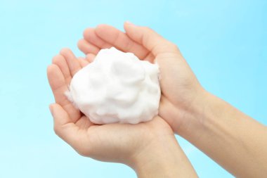 Foam of soap and female hands