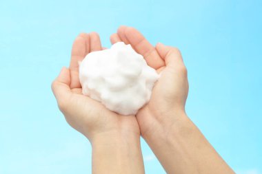 Foam of soap and female hands