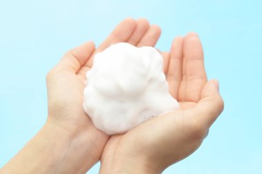 Foam of soap and female hands