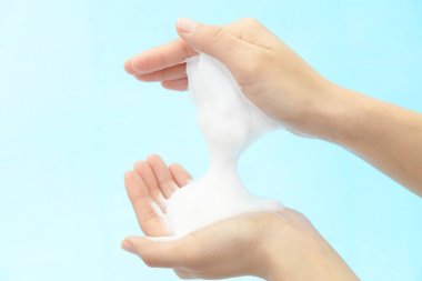 Foam of soap and female hands