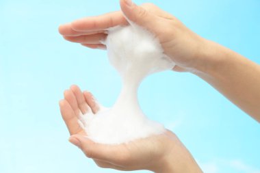 Foam of soap and female hands