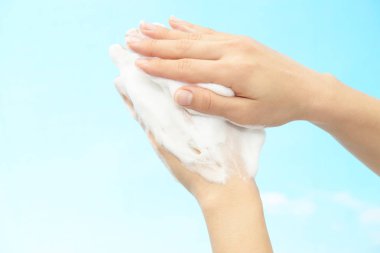 Foam of soap and female hands
