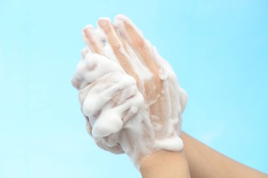 Foam of soap and female hands