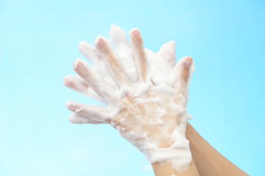 Foam of soap and female hands
