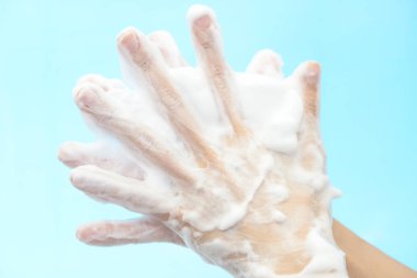 Foam of soap and female hands