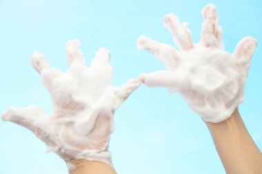 Foam of soap and female hands