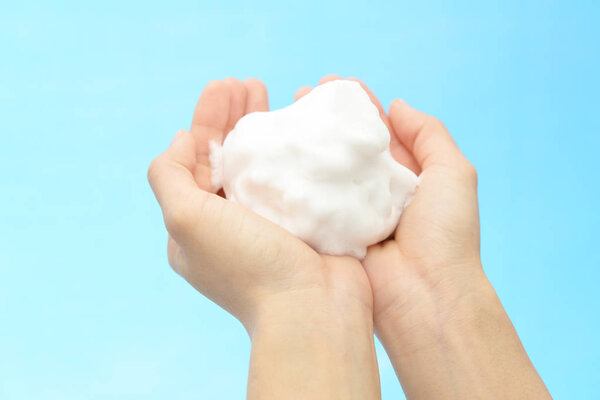 Foam of soap and female hands