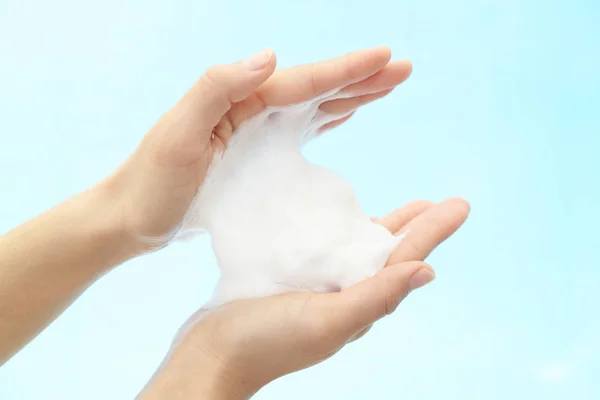 Foam of soap and female hands