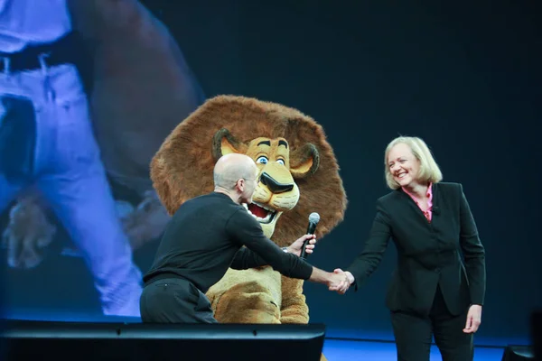 LAS VEGAS, NV - JUNE 5, 2012: HP CEO Meg Whitman and DreamWorks CEO Jeffrey Katzenberg deliver an address to HP Discover 2012 conference with cartoon character lion on June 5, 2012 in Las Vegas, NV — Stock Photo, Image