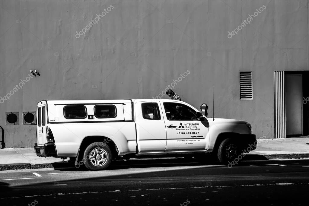 SAN FRANCISCO, CA - SEPT 20, 2010: White Toyota Tacoma car with the Mitsubishi Electric Elevators and Escalators logo stands in a paid parking lot on the street on Sept 20, 2010 in San Francisco, CA