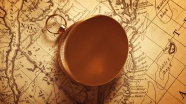 Golden Compass On The Map Indicating Direction