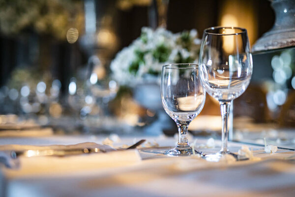 Luxury table settings for fine dining with and glassware, beautiful blurred  background. For events, weddings.  props for weddings, birthdays, and celebration. Wedding, restaurant,