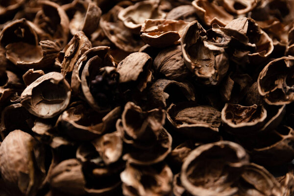 top view of walnut shell on a contrasting background,a large number of peeled walnut shells,walnut texture