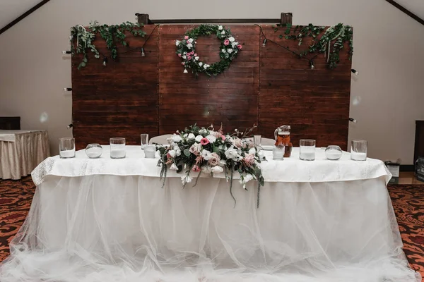 wedding decor in the banquet hall,wedding table decorated with wedding decorations,honeymoon table,arrangement of holiday dishes on the table,seating at the wedding table