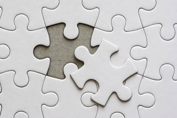 Close Blank White Jigsaw Puzzle Pieces One Piece Removed Side Stock Photo  by ©stefan_alfonso 334354226