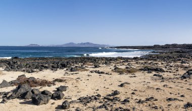 Shore of Fuerteventura with Lanzarote Island visible in the distance