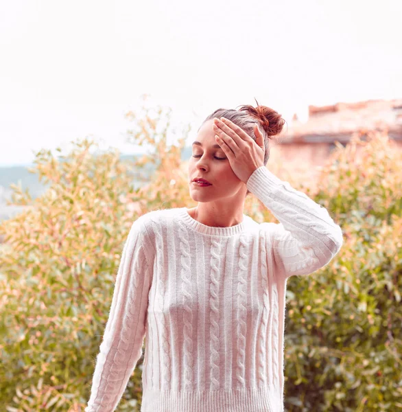 Pretty laughing beautiful young woman in white sweater and underwear, standing on balcony. Tuscany, Italy. Small depth of field. — Stock Photo, Image