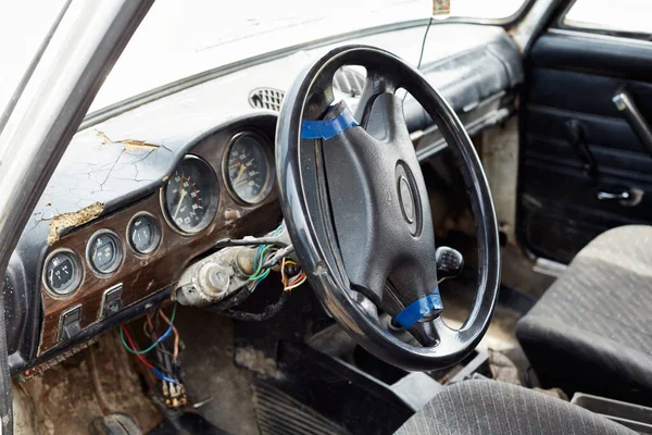 The very damaged interior of an old car from the 1980s