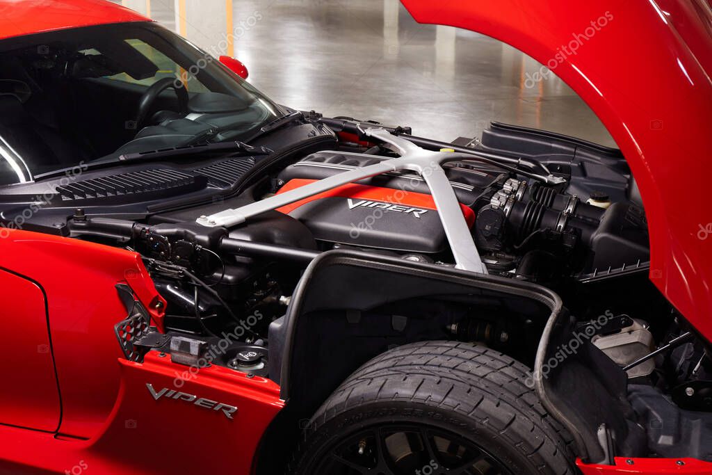 Warsaw / Poland, 06.16.2018: Dogde Viper with open bonnet and engine V10, 8.4 L, 640 hp, parked in an underground garage.