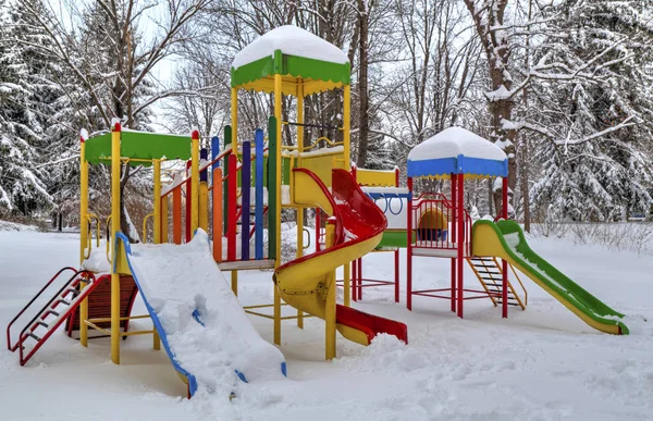 Children\'s playground covered with snow
