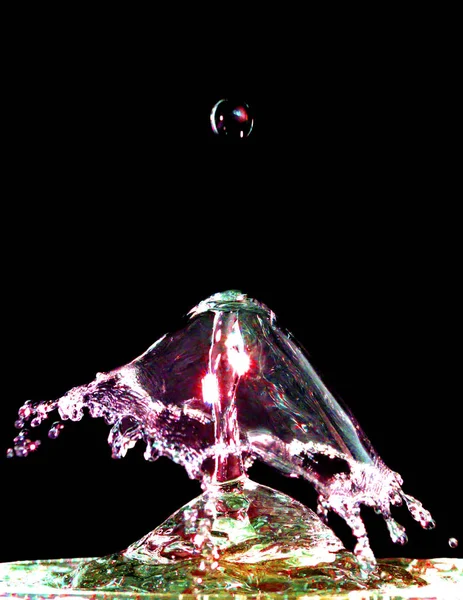 Colorful liquid splash isolated on black background — Stock Photo, Image