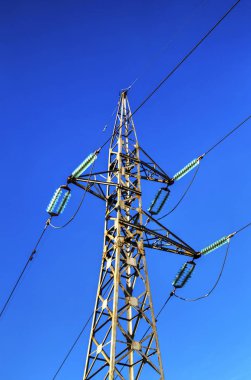 Mavi gökyüzünde bir elektrik hattı direği