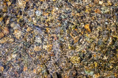 Beautiful pebbles underwater in the river for background