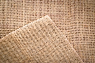 Çarşaf arka planı. Doğal organik bej tuval. Kahverengi örülmüş arka plan. Keten dokuma Malzeme pamuk arka planı