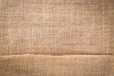 Çarşaf arka planı. Doğal organik bej tuval. Kahverengi örülmüş arka plan. Keten dokuma Malzeme pamuk arka planı