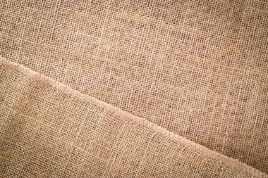 Tuvalin arka planı. Keten doğal organik bej fon. Dokuma malzemesi kahverengi doku