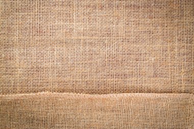 Çarşaf arka planı. Doğal organik bej tuval. Kahverengi örülmüş arka plan. Keten dokuma Malzeme pamuk arka planı