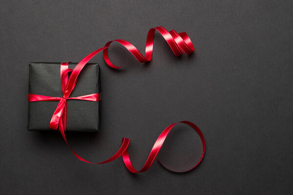 Xmas background. Black Christmas gifts, ornaments on black background. Winter holiday present. Merry Christmas and Happy Holidays greeting card, frame, banner