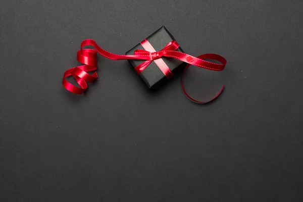 Cinta de caja de regalo. Regalos de Navidad, decoración roja sobre fondo negro. Un regalo de Navidad. Concepto de vacaciones de invierno. Año Nuevo. Noel. . —  Fotos de Stock
