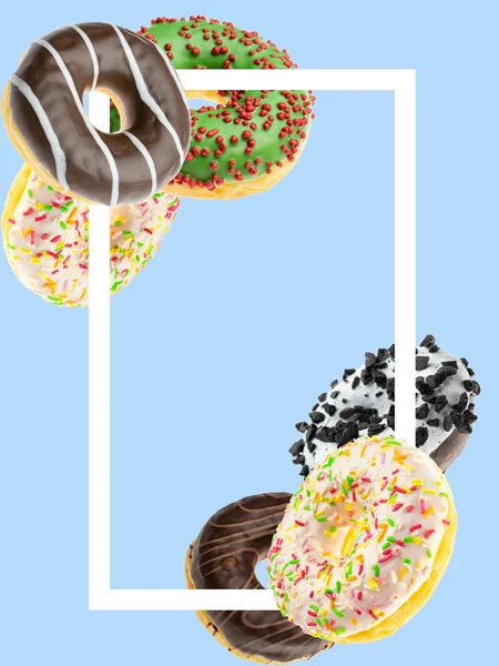 Flying background. Falling chocolate donuts isolated on blue. Frame for text. Glazed sprinkles. — 스톡 사진