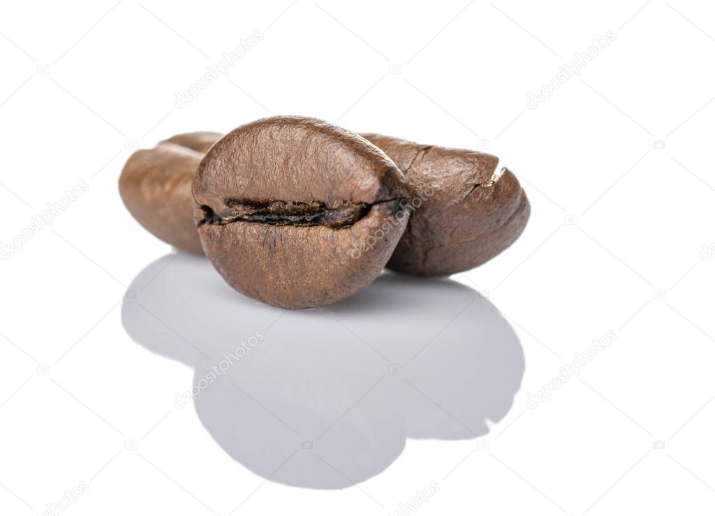 Coffee seeds roasted beans isolated on white. Coffee background for espresso mocha or cappuccino.