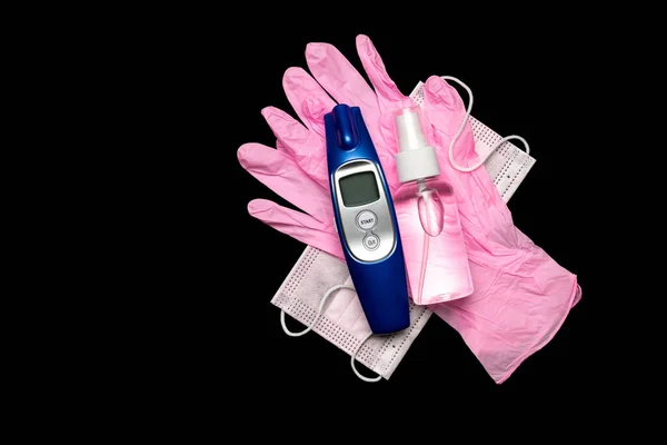 Protection covid. Medical respirator bandage face sanitizer gel, Electronic thermometer and lab gloves - Virus protection equipment on black background. Dangerous Chinese COVID-19, pandemic risk alert Royalty Free Stock Images
