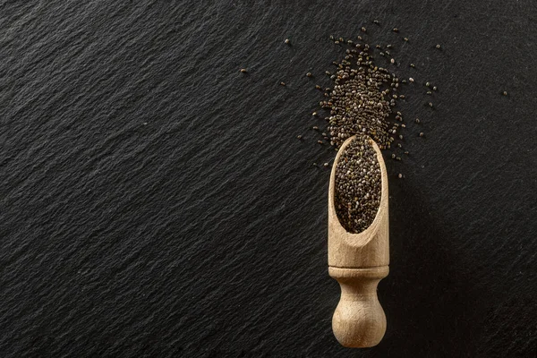 Semillas de lino chía en cuchara de madera sobre fondo negro. Un montón de superalimentos. Vitamina antioxidante desayuno o merienda de la mañana dieta comer concepto . — Foto de Stock