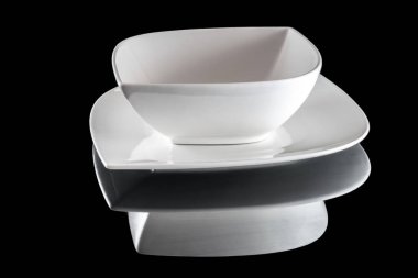 Siyah üzerine izole edilmiş yiyecek için beyaz tabak boş. Karanlık arka planda akşam yemeği için yuvarlak tabak. Restoran mutfağı minimalist konsepti