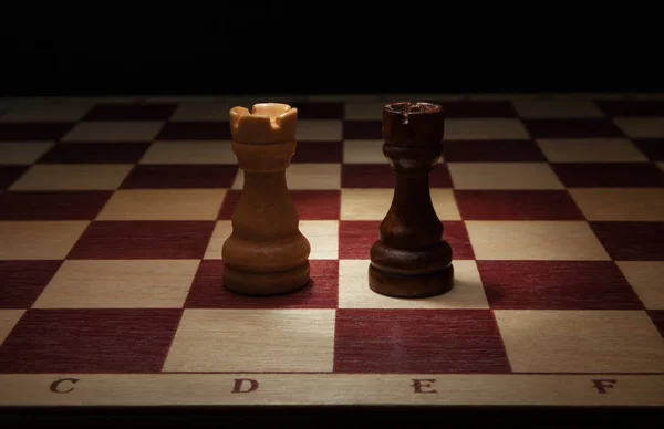 Wooden chess. Black and White Rook on chess board. — Stock Photo, Image