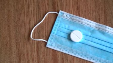 Mavi tıbbi maskeli virüs hapı. Coronavirus için uyuşturucu arama ve aşı geliştirme