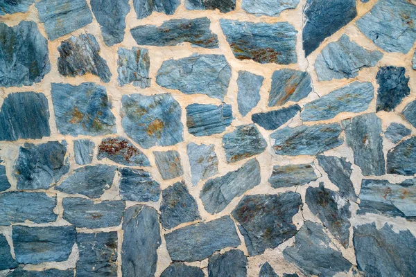 Detailed stone wall background in blue tones. Blue stones