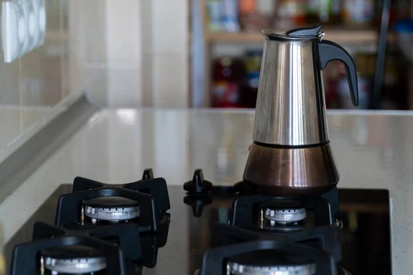 Italian coffee maker on the gas stove. Metal coffee maker in a kitchen.