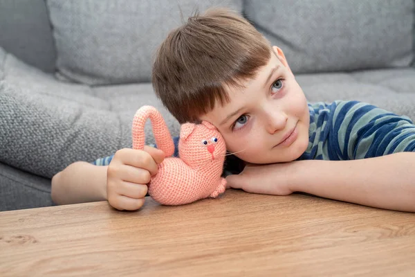 Cute child blond boy in casual clothes playing with handmade toy. — Stock Photo, Image