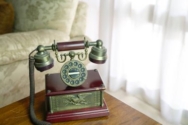 Classic vintage phone on a wooden top